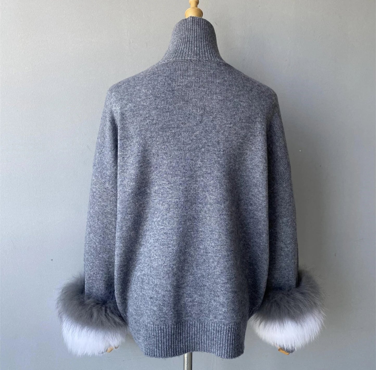 Luxury cashmere jumpers with natural fur cuffs . Jackets