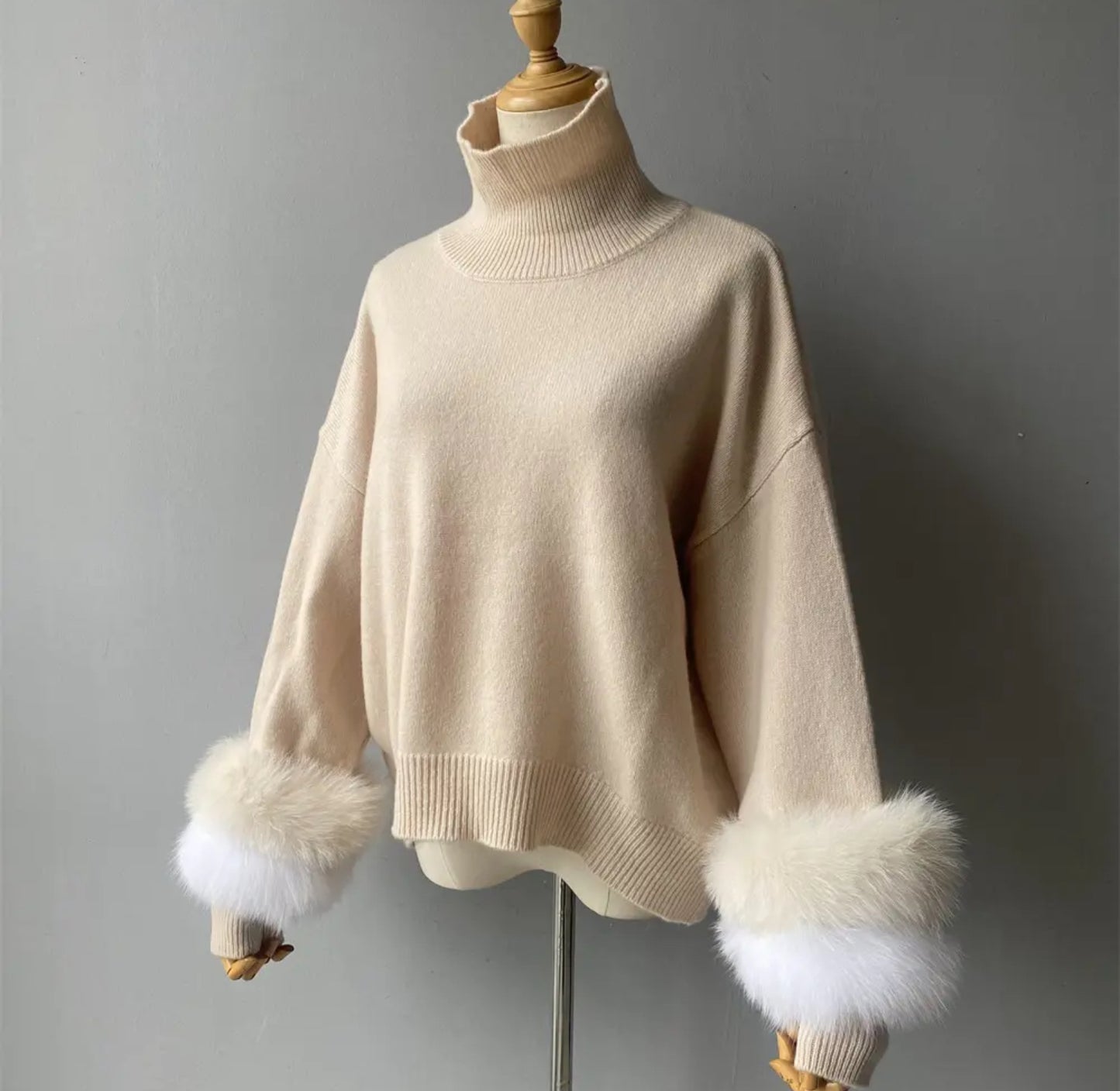 Luxury cashmere jumpers with natural fur cuffs . Jackets