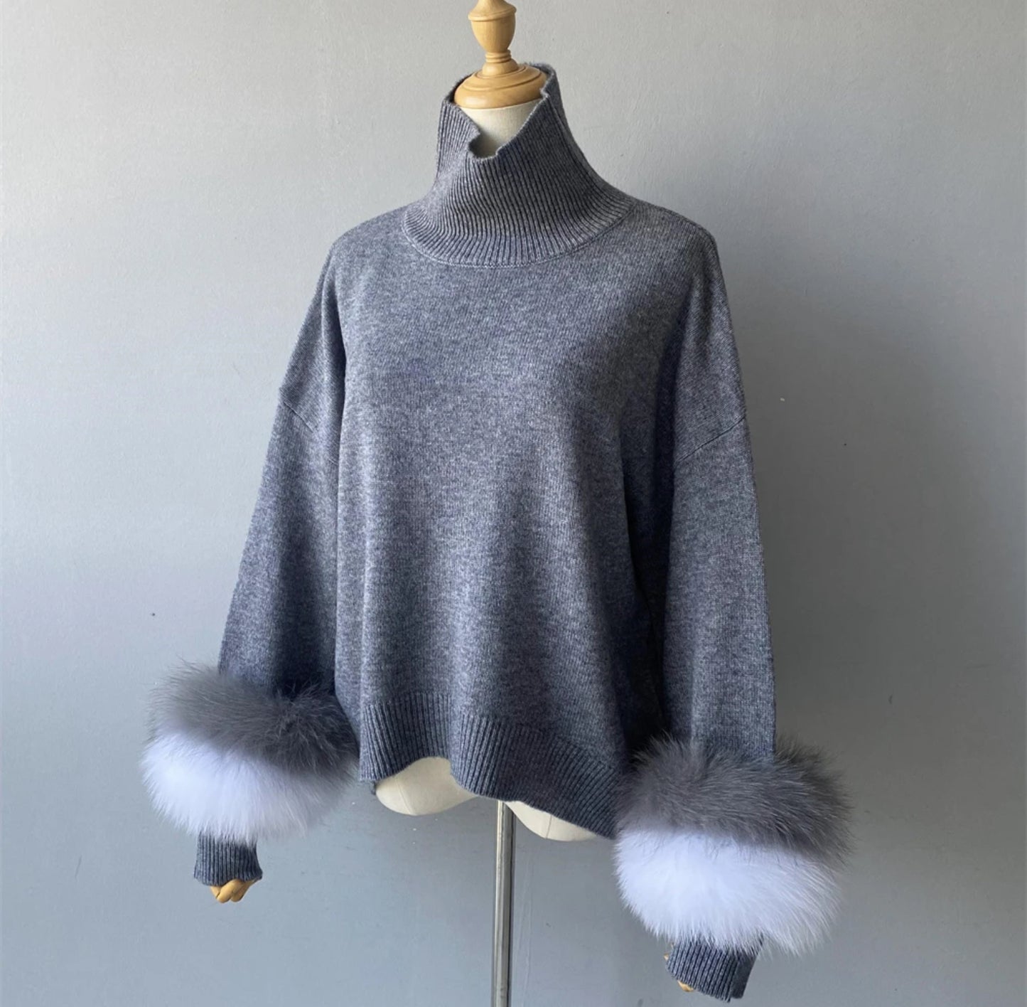 Luxury cashmere jumpers with natural fur cuffs . Jackets