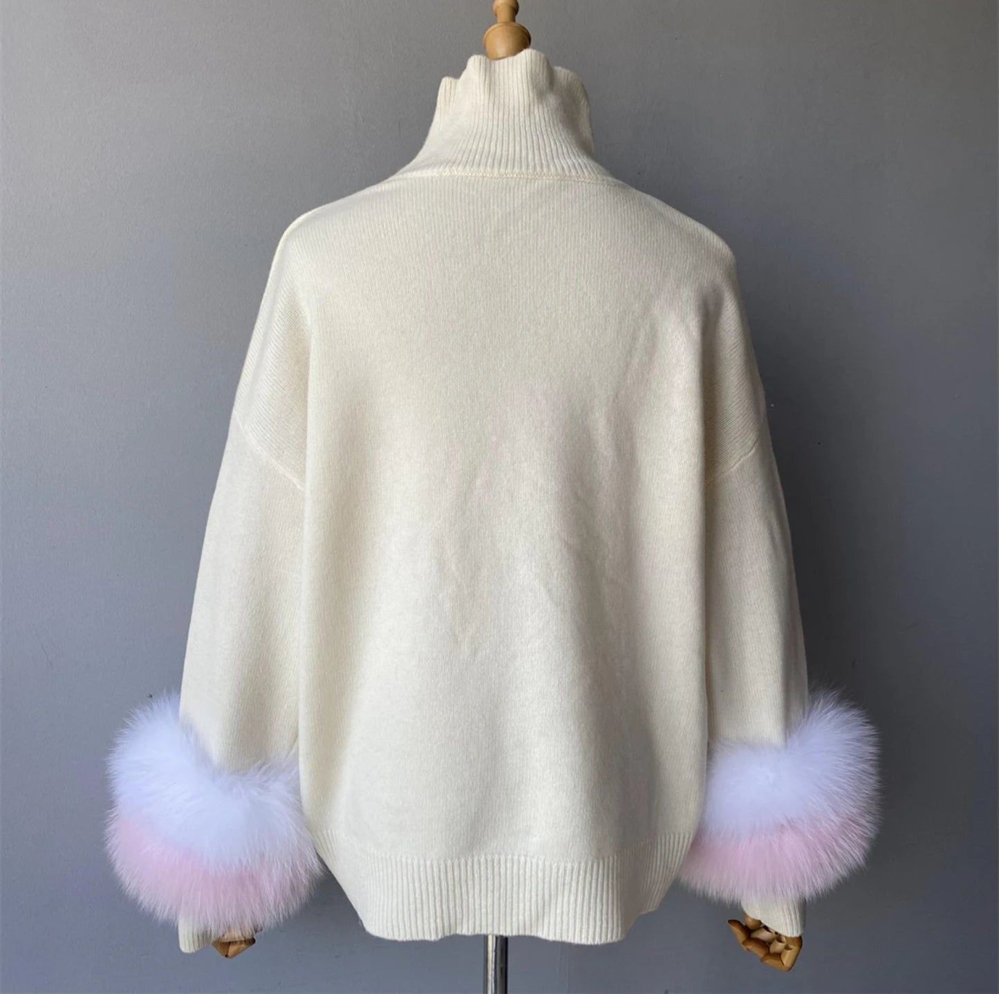 Luxury cashmere jumpers with natural fur cuffs . Jackets