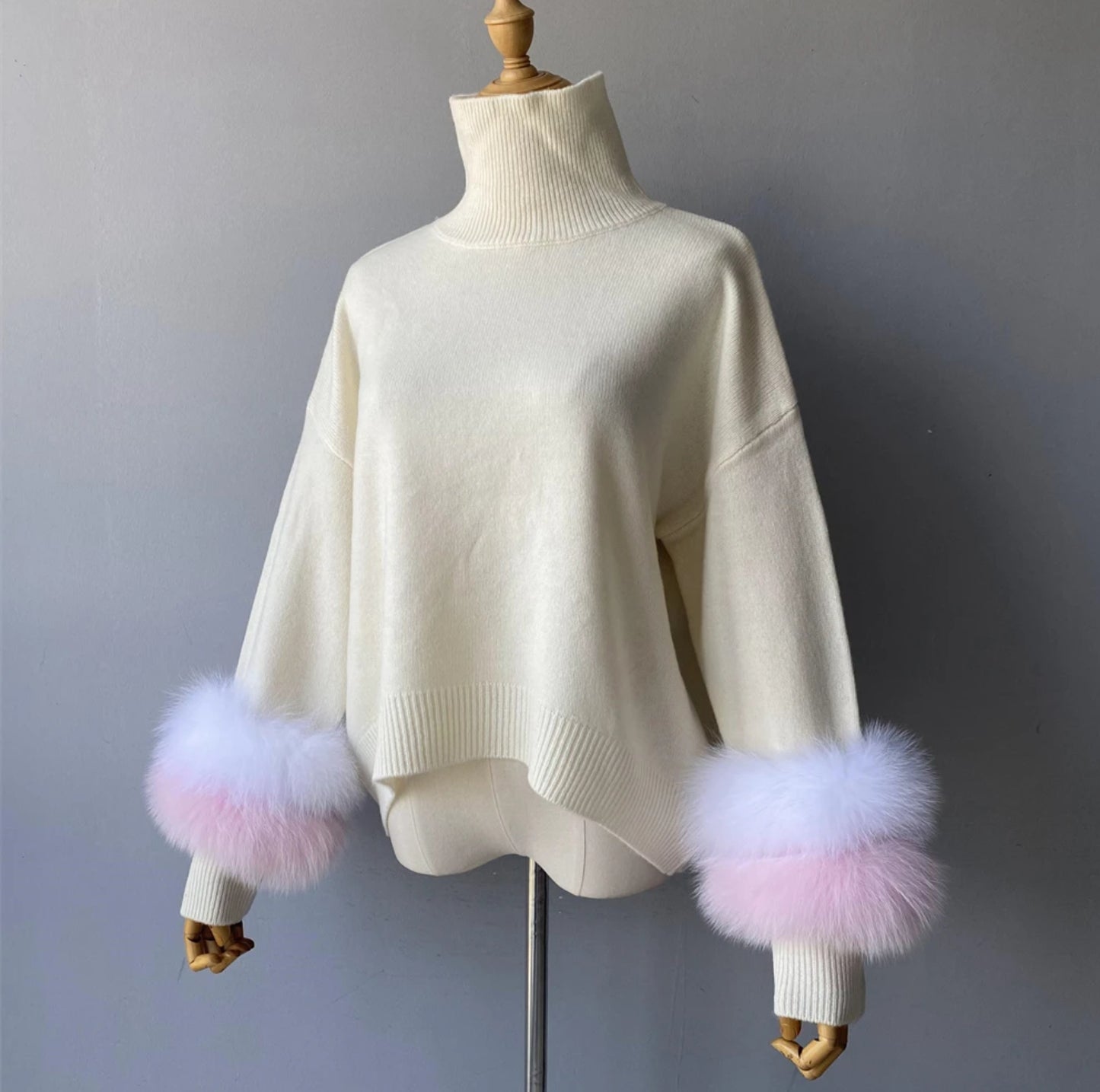 Luxury cashmere jumpers with natural fur cuffs . Jackets