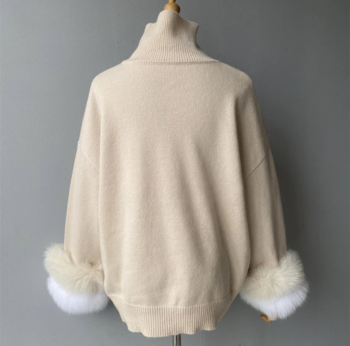 Luxury cashmere jumpers with natural fur cuffs . Jackets