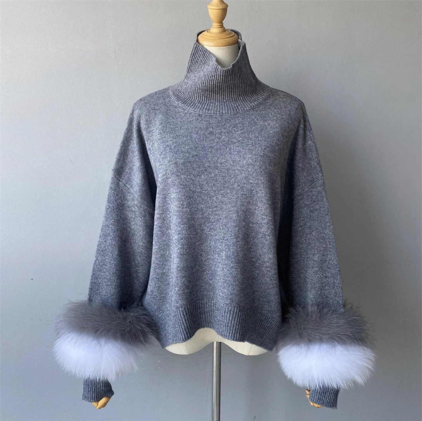 Luxury cashmere jumpers with natural fur cuffs . Jackets