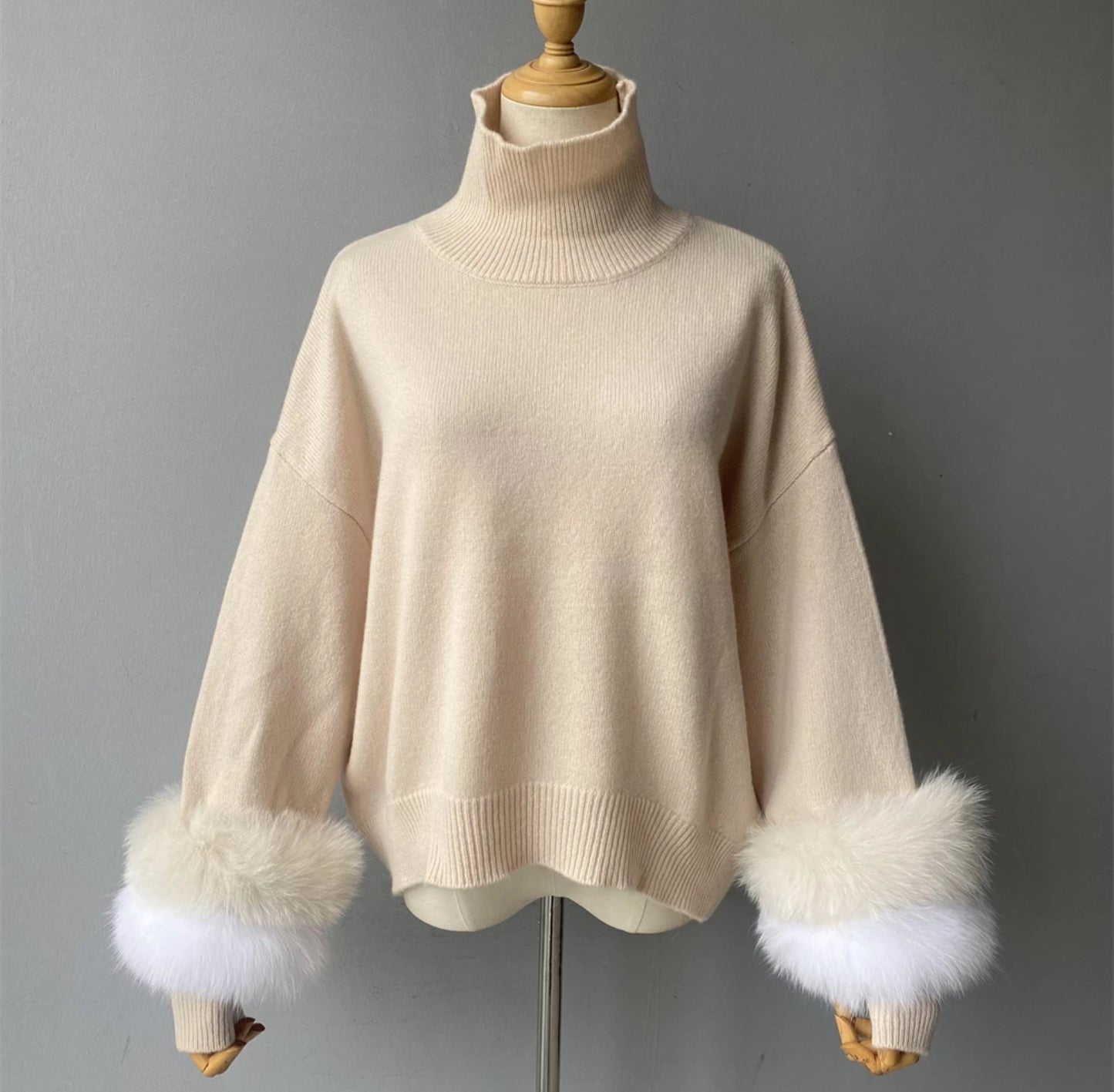 Luxury cashmere jumpers with natural fur cuffs . Jackets